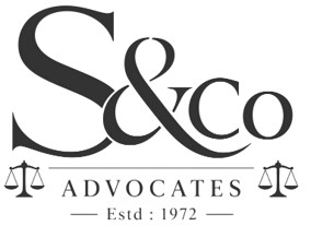Stylized wording 'S&Co ADVOCATES Estd: 1972' along with scales of justice devices on either side trademark artwork